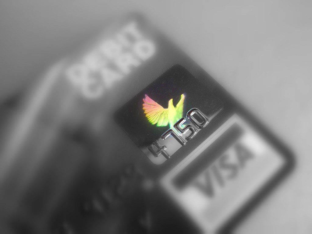 Debit card and laptop on a desk