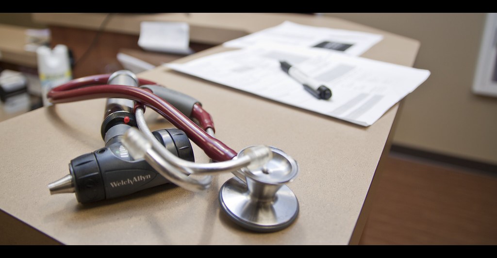 Stethoscope on a desk with paperwork