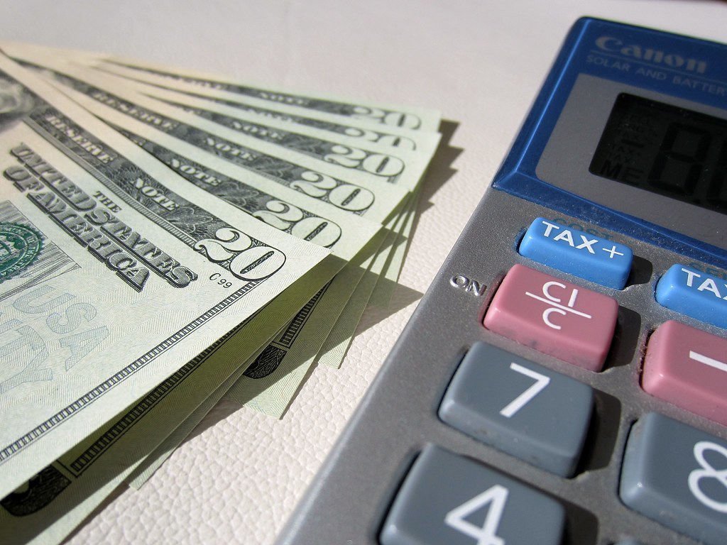 Accounting ledger and calculator on a desk